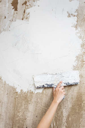 spatula with putty on the wallの写真素材