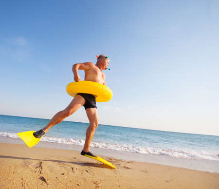 man in flippers and mask on the bank of the seaの写真素材