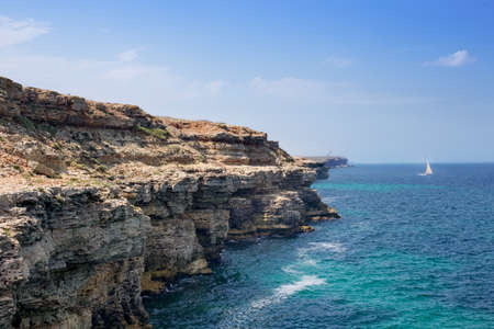 beautiful rocky sea coast under blue skyの写真素材