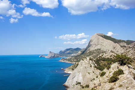 beautiful rocky sea coast under blue skyの写真素材