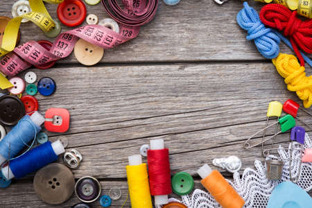 thread and sewing on wooden boardsの写真素材