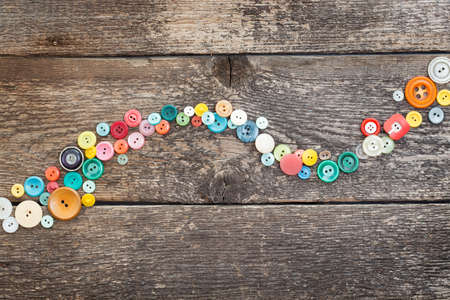 old buttons on wooden boardsの写真素材