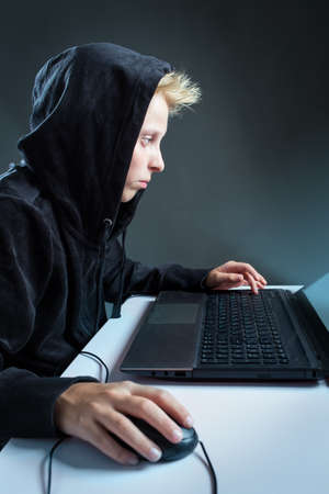 Teenager sitting behind a computer