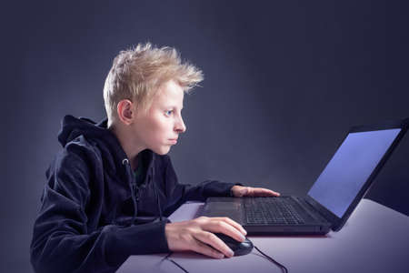 Teenager sitting behind a computer