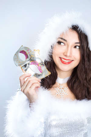 beauty brunette girl in santa hat on gray backgroundの写真素材
