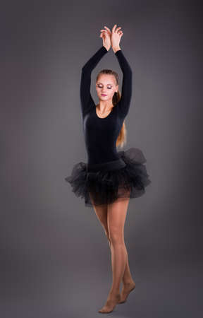 Young woman dancer on the dark backgroundの写真素材