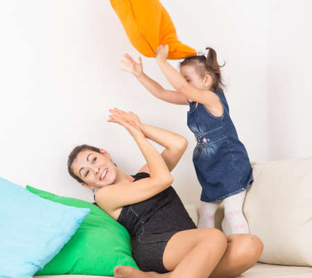 mother playing with her baby pillowsの写真素材