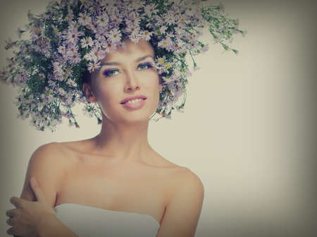 The girl in a wreath of purple daisiesの写真素材