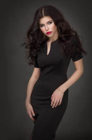 Seductive brunette in a black dressの写真素材