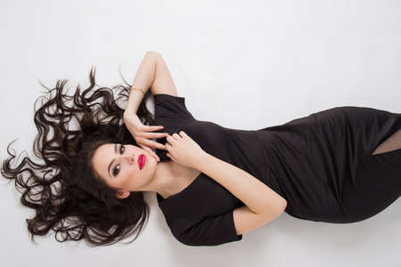 Seductive brunette in a black dressの写真素材