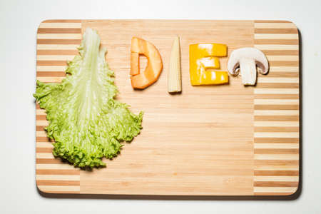 Vegetables in the form of letters on a cutting boardの写真素材