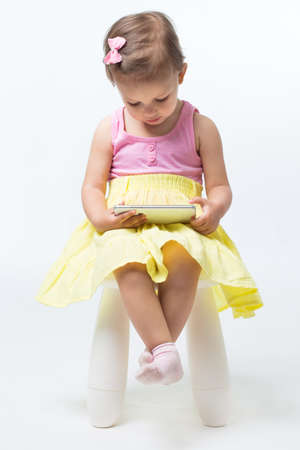 Girl two years of playing the game on your phoneの写真素材