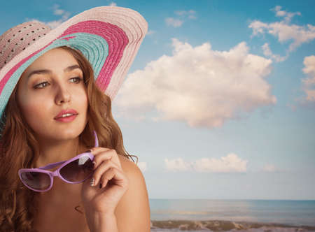 Young beautiful woman with a hat in the hot summerの写真素材