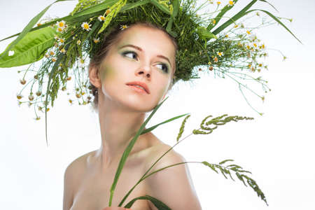 Beautiful girl wearing a wreath of wildflowersの写真素材