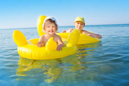 Child swims in the sea in inflatable ringの写真素材