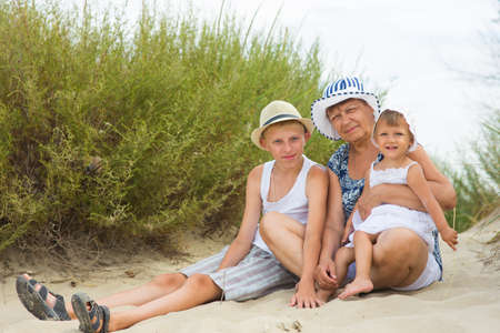 Grandmother playing with her grandchildren in natureの写真素材