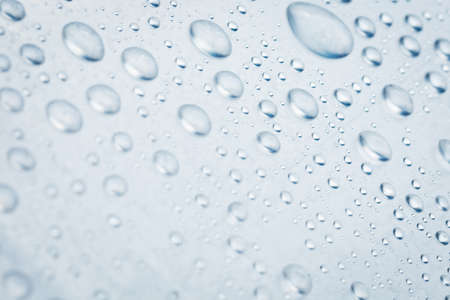 Drops of water on a light surface close.Macro water drop.