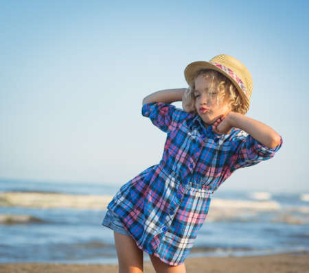 Girl playing on the beach near the seaの写真素材