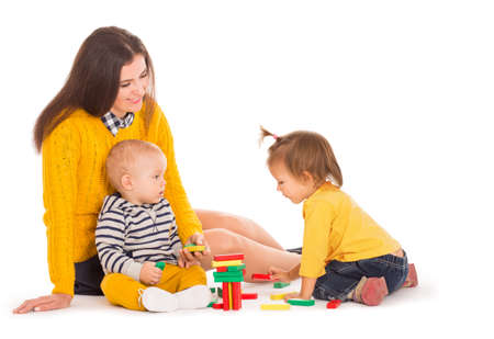 Mom and two kids playing with blocksの写真素材