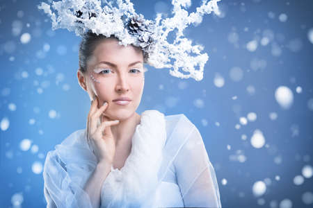 Face of a young woman on a snowy backgroundの写真素材