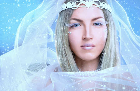 Face of a young woman on a snowy backgroundの写真素材