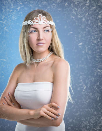 Face of a young woman on a snowy backgroundの写真素材