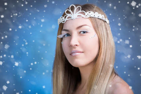 Face of a young woman on a snowy backgroundの写真素材