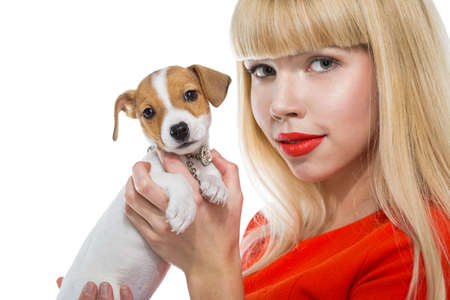 blonde woman with a puppy Jack Russell on a white backgroundの写真素材