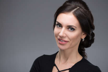 Portrait of a beautiful young woman in a black dressの写真素材