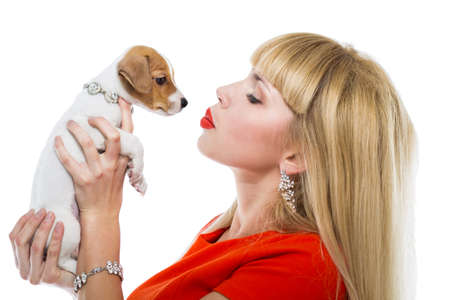 blonde woman with a puppy Jack Russell on a white backgroundの写真素材