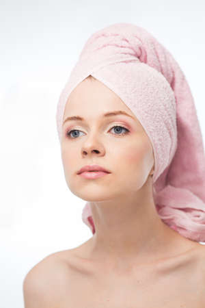 Face of a beautiful young woman with a towel on a white backgroundの写真素材