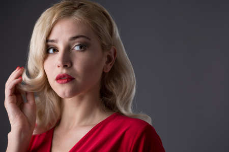 Beautiful girl with hair the evening in the studioの写真素材