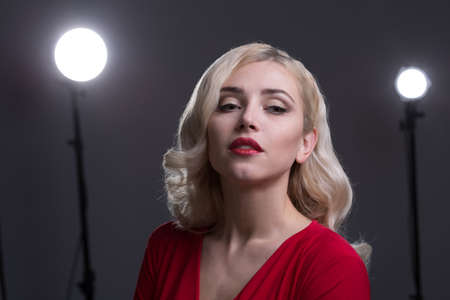 Beautiful girl with hair the evening in the spotlightの写真素材