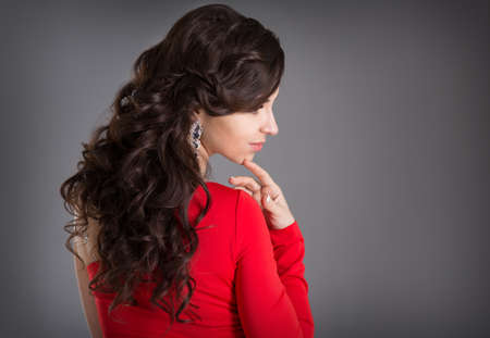 The girl with ringlets in a red dressの写真素材