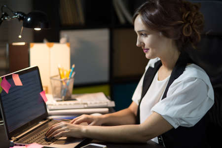 Portrait of a businesswoman sitting at her workplace in officeの写真素材