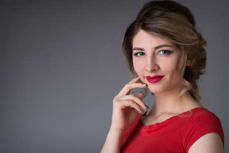 beautiful young woman with hair in the evening red dressの写真素材