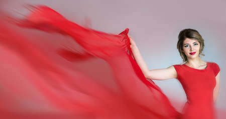 beautiful young woman with hair in the evening red dressの写真素材