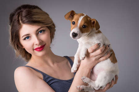 beautiful young woman with a puppy Jack Russellの写真素材