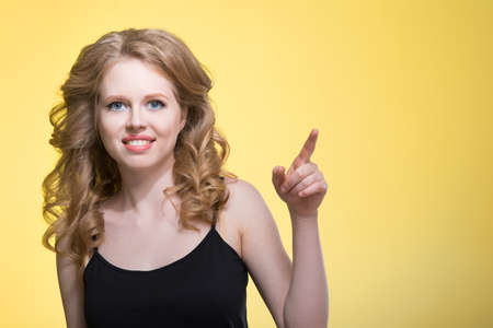 Young beautiful woman on a yellow backgroundの写真素材