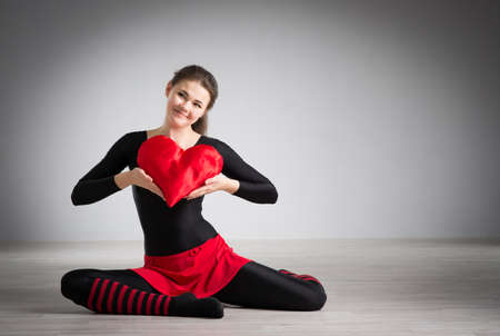 young girl with a heart in his handsの写真素材