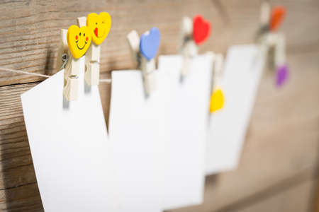 White card on clothespins hanging on the rope
