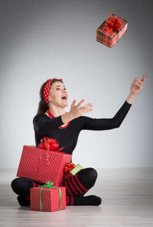 cheerful girl with a gifts in their handsの写真素材