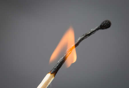 burning match on a gray backgroundの写真素材