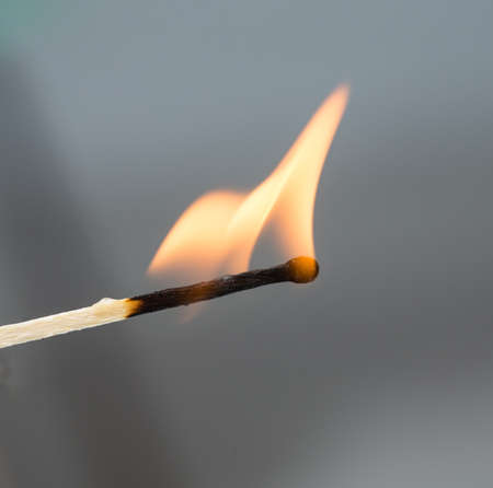 burning match on a gray backgroundの写真素材
