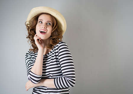 Young beautiful cheerful woman on a grey backgroundの写真素材