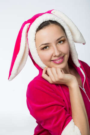 Young woman in a pink jacket with rabbit earsの写真素材