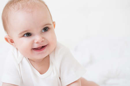 Kid seven months of age on the bedの写真素材