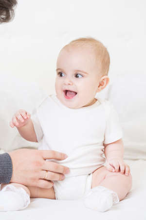 Kid seven months of age on the bed