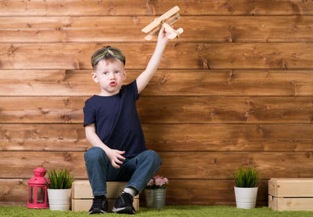 Boy playing with a model airplaneの写真素材