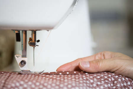 Sewing machine and women's handsの写真素材
